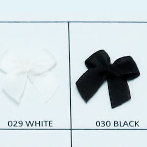 May include: A color chart of eight different colored satin ribbon bows. The colors are shell gray, silver gray, off white, white, black, light pink, tulip, and pink.