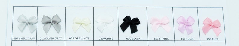May include: A color chart of eight different colored satin ribbon bows. The colors are shell gray, silver gray, off white, white, black, light pink, tulip, and pink.