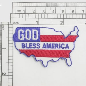 May include: An embroidered patch in the shape of the United States of America with a red, white and blue American flag design. The patch says "GOD BLESS AMERICA" in white lettering.