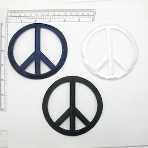 May include: Three peace sign patches in different colors: navy blue, white, and black. The patches are made of satin fabric and have a slightly raised texture.