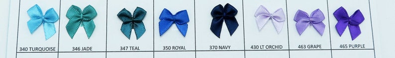 May include: A color chart of satin ribbon bows in various colors, including turquoise, jade, teal, royal blue, navy, light orchid, grape, and purple. Each bow is labeled with its corresponding color code.