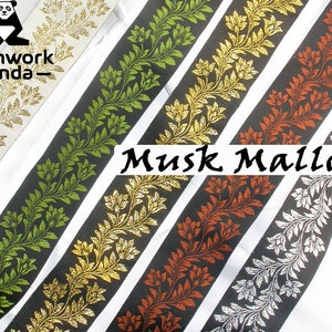 May include: Five different colored ribbon trims with a black background and a floral design. The colors are green, gold, orange, silver, and white. The text "Musk Mallow" is printed on the ribbon trims.