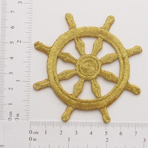 Può includere: Toppa ricamata in oro a forma di timone di nave, che misura circa 5 cm di diametro.