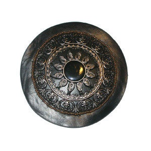 May include: A round, silver-colored metal decorative wall plaque with a black center and intricate floral designs.
