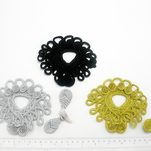 May include: Three sets of decorative Chinese knot closures. The knots are made of braided cord and come in black, silver, and gold.