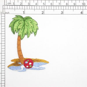 May include: Embroidered iron-on patch of a green palm tree with a brown trunk on a yellow island with a red and white beach ball.