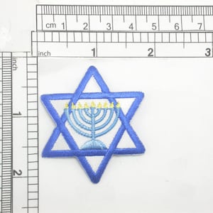May include: A blue embroidered Star of David with a white background and a yellow menorah in the center.