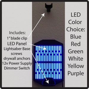 May include: A blue LED lightsaber base with a 1" blade clip, screws, drywall anchors, a 12v power supply, and a dimmer switch. The base is mounted on a wall and has a blue LED panel. The LED color can be chosen from blue, red, green, white, yellow, or purple.