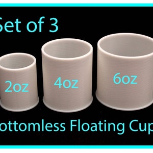 Peut inclure: Ensemble de trois gobelets flottants sans fond blancs. Les gobelets sont étiquetés 2oz, 4oz et 6oz.