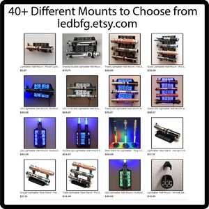 May include: A collage of 12 images showing different lightsaber wall mounts and desk stands. The mounts are made of metal and wood and are designed to hold lightsabers of various sizes. The images show a variety of styles, including single, double, and triple lightsaber mounts. The text on the images includes the name of the mount, the price, and the website address ledbfg.etsy.com.