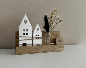 Wooden strip with decorative houses and flower vase