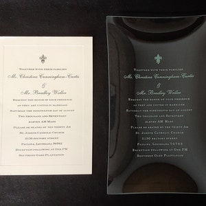 May include: Two white wedding invitations with black text. The invitations announce the marriage of Christina Cunningham-Curtis and Bradley Waller. The ceremony will take place on Saturday, August 19th, 2017 at 11:00 AM at St. Joseph Catholic Church in Paulina, Louisiana. The reception will follow at 1:00 PM at Southern Oaks Plantation.
