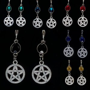 May include: A set of silver tone earrings with a pentagram charm and a dangling crystal. The crystals are available in a variety of colors, including red, blue, green, black, and yellow.