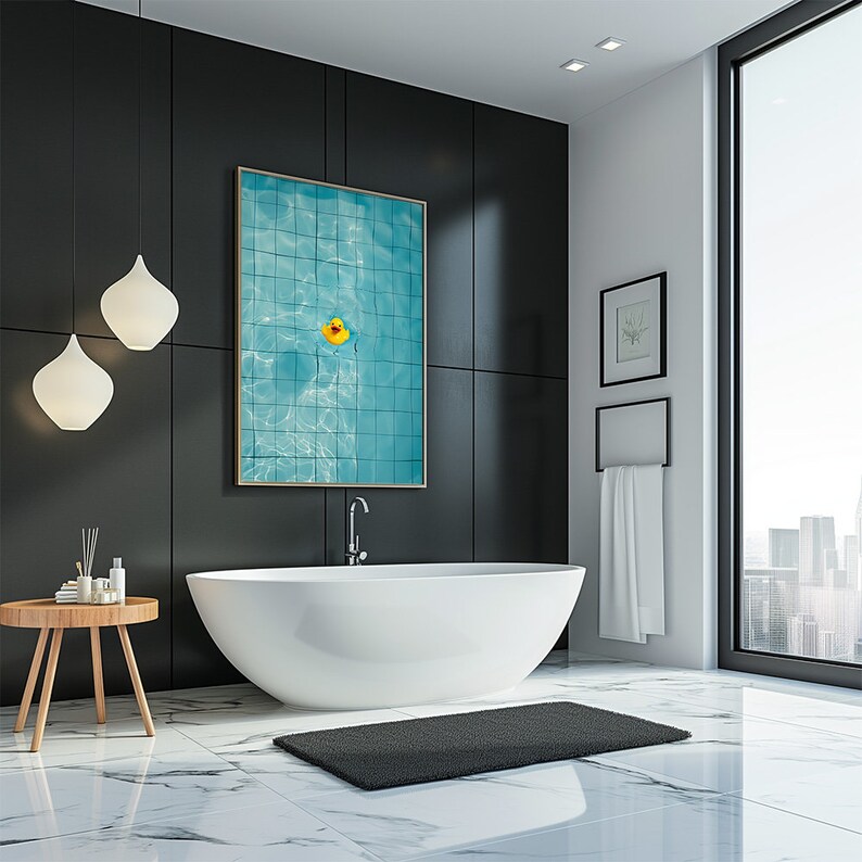 May include: A modern bathroom with a large white bathtub, a black rug, and a framed picture of a swimming pool with a yellow rubber duck. The walls are black and white, with a large window overlooking a cityscape.