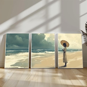 May include: Set of three canvas art prints depicting a serene beach scene. The artwork features a person with a large sun hat standing on the beach, with ocean waves and a cloudy sky. The color palette includes blues, beige, and greens.
