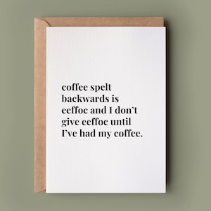 May include: A white greeting card with a brown envelope featuring black text that reads: coffee spelt backwards is eeffoc and I don't give eeffoc until I've had my coffee. The card has a clean, minimalist design with a simple serif font.