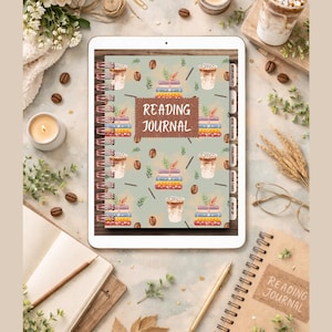 May include: A white tablet displays a spiral-bound reading journal with a cover design featuring stacks of books and coffee cups. The journal's cover has the words "READING JOURNAL" in a brown banner. The image is surrounded by coffee beans, flowers, and stationery.
