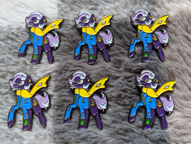 a bunch of pins with a cartoon character on them