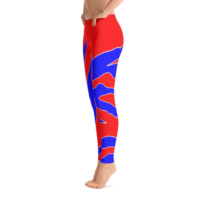May include: Red and blue leggings with a geometric pattern. The leggings are form-fitting and have a high waist.