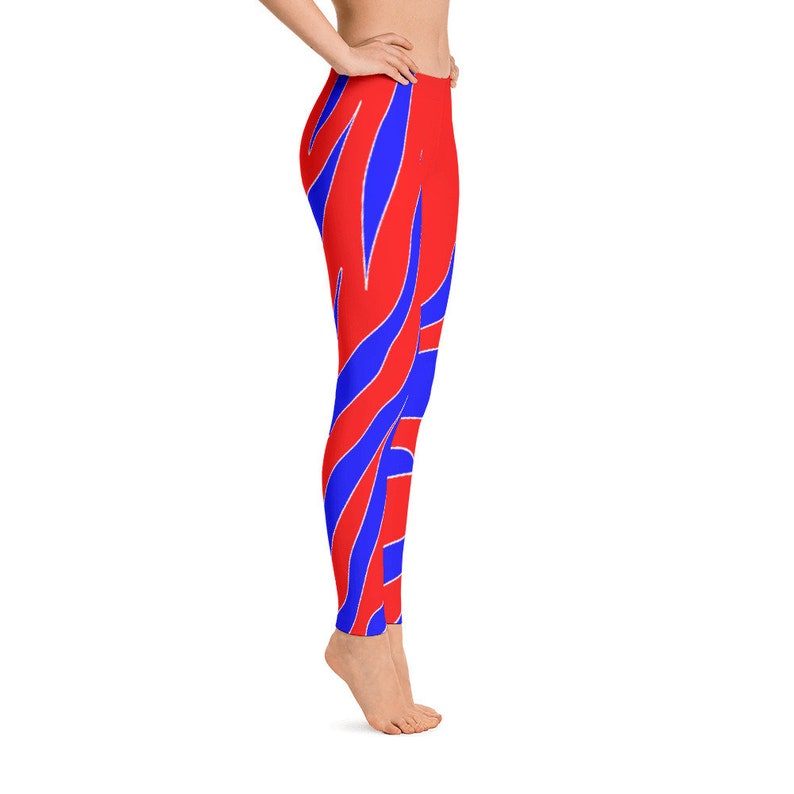 May include: Red and blue striped leggings with a wavy pattern. The leggings are form-fitting and have a high waist.