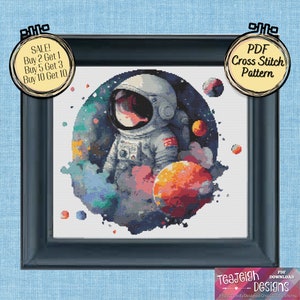 May include: A PDF cross stitch pattern featuring an astronaut in a space suit with planets and stars in the background. The astronaut is surrounded by a watercolor-style nebula. The pattern is available for download.