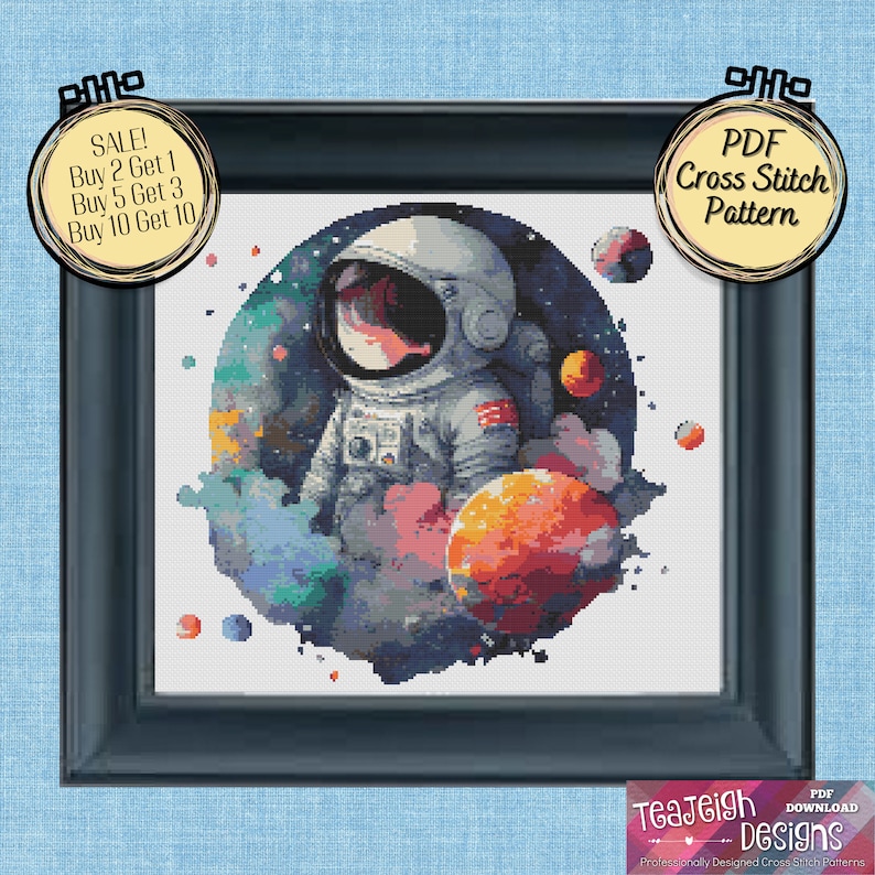May include: A PDF cross stitch pattern featuring an astronaut in a space suit with planets and stars in the background. The astronaut is surrounded by a watercolor-style nebula. The pattern is available for download.