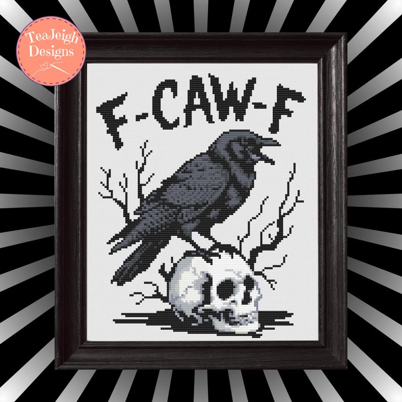 May include: Framed cross-stitch art featuring a black crow perched atop a skull, with the text "F-CAW-F" above. The artwork is in a dark wooden frame, with a black and white striped background.