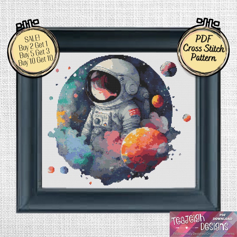 May include: A cross stitch pattern featuring a watercolor-style illustration of an astronaut in space. The astronaut is wearing a white spacesuit and is surrounded by colorful planets and stars. The pattern is available as a PDF download.