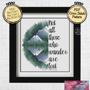 May include: A cross stitch pattern featuring a quote by J.R.R. Tolkien: "Not all those who wander are lost." The pattern depicts a mountain range with trees and a reflection in a lake.