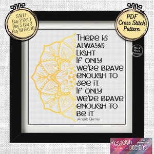 May include: A black and white cross stitch pattern with a gold mandala design and the quote "There is always light if only we're brave enough to see it. If only we're brave enough to be it." by Amanda Gorman.