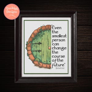 May include: Framed cross-stitch art featuring a green hobbit door with a brick archway. The quote "Even the smallest person can change the course of the future" is displayed in black text. The artwork is framed in a dark brown frame.