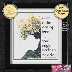 May include: Framed cross-stitch pattern featuring a woman's silhouette with a tree-like design and the quote "Lost in the lore of trees, my soul sings earthen melodies." Includes a "PDF Cross Stitch Pattern" label.