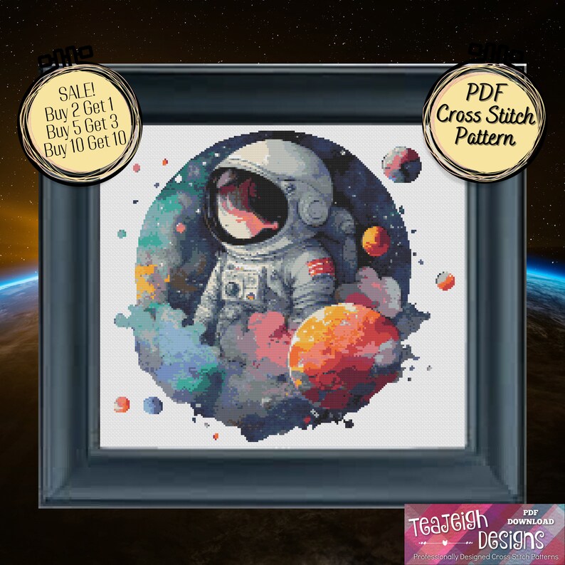 May include: A PDF cross stitch pattern featuring a cartoon astronaut in a space suit standing in front of a colorful nebula with planets. The pattern is framed in a black frame with the text "PDF Cross Stitch Pattern" in a yellow circle.