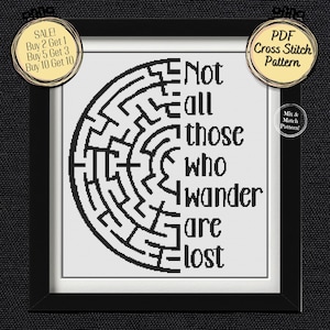 May include: A framed cross-stitch pattern with a black and white design. The design features a maze on the left and the quote "Not all those who wander are lost" on the right. Includes text that says "PDF Cross Stitch Pattern" and "Mix & Match Pattern!"