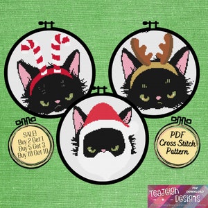 May include: Three black cat cross stitch patterns in embroidery hoops. The cats are wearing different Christmas accessories: candy canes, reindeer antlers, and a Santa hat. The text on the image reads "SALE! Buy 2 Get 1, Buy 5 Get 3, Buy 10 Get 10" and "PDF Cross Stitch Pattern".