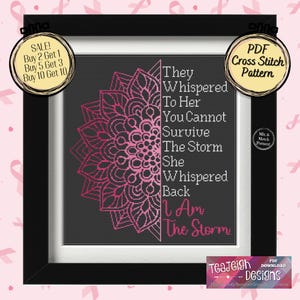 May include: A black and white cross stitch pattern with a pink mandala design and the text "They whispered to her you cannot survive the storm she whispered back I am the storm".