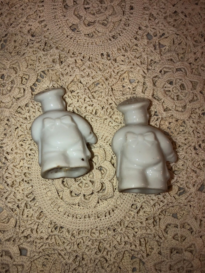 Paint rubbed off in places Chef salt and pepper shakers see pics. vintage Sunshine Crackers bakers salt and pepper set