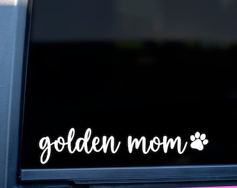 May include: A pink car with a black window and a white vinyl decal that says "golden mom" with a paw print.
