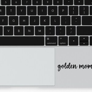 Black Golden Mom decal with a paw print placed on a laptop.