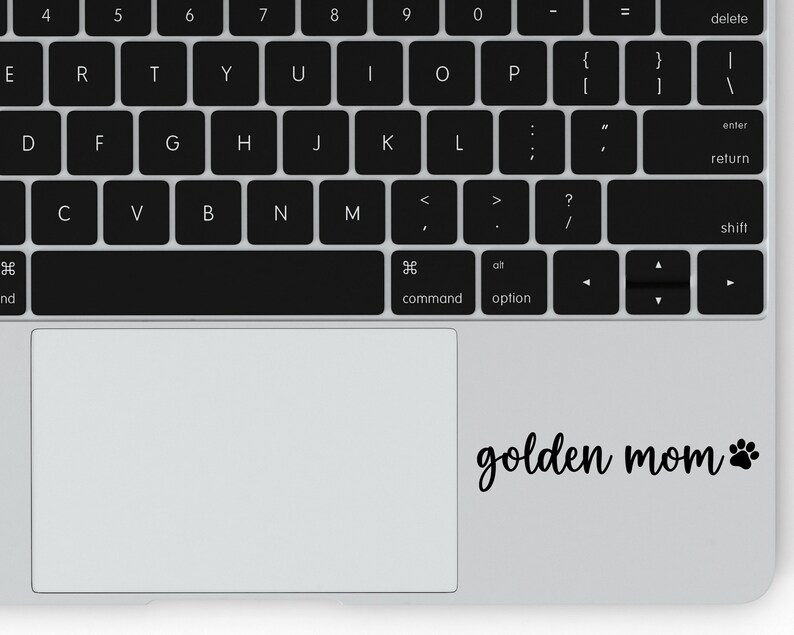 Black Golden Mom decal with a paw print placed on a laptop.