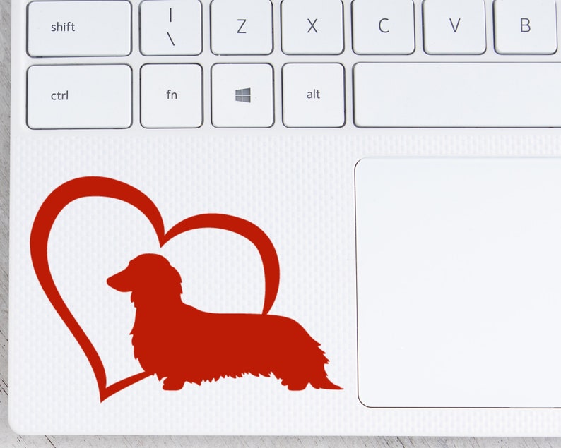 Red Long Haired Dachshund decal with a heart placed on a laptop.