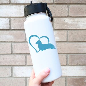 Blue Long Haired Dachshund decal with a heart placed on a water bottle.