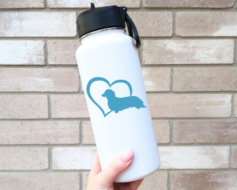 Blue Long Haired Dachshund decal with a heart placed on a water bottle.