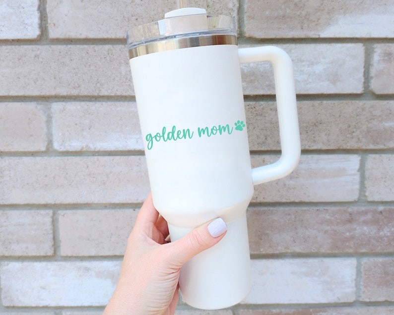 Mint Golden Mom decal with a paw print placed on a tumbler.