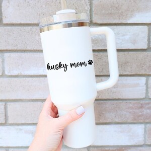 Black Husky Mom decal with a paw print placed on a tumbler.