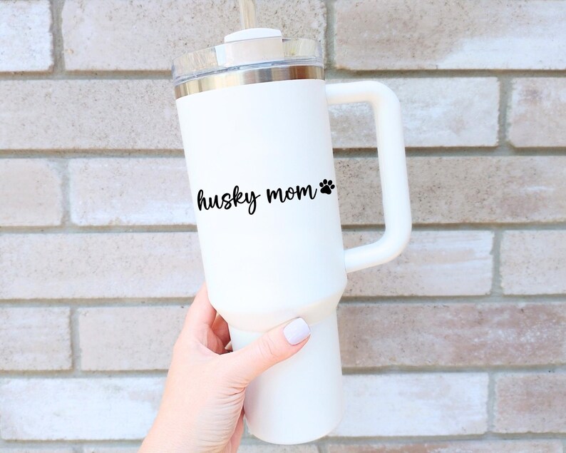 Black Husky Mom decal with a paw print placed on a tumbler.