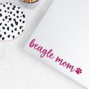 Pink Beagle Mom decal with a paw print placed on a laptop.