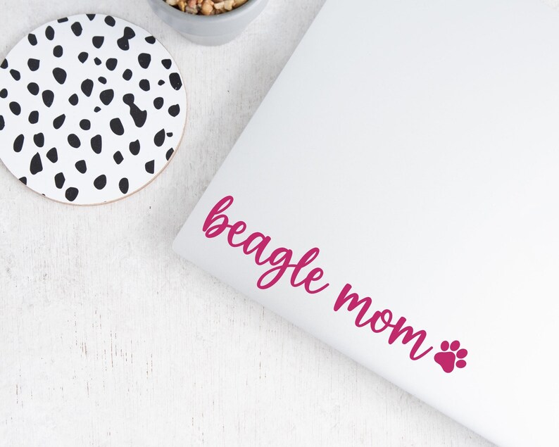 Pink Beagle Mom decal with a paw print placed on a laptop.
