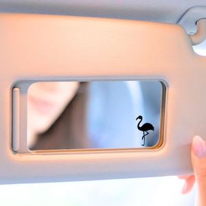 Tiny Flamingo decal on car mirror.