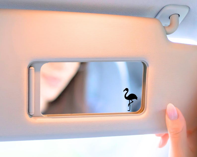 Tiny Flamingo decal on car mirror.
